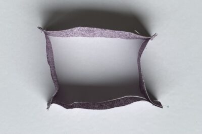 purple fabrics with quilt batting on white table