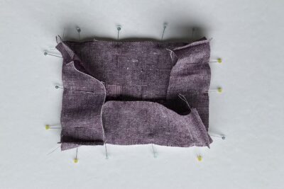 purple fabrics with quilt batting on white table