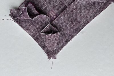 purple fabrics with quilt batting on white table