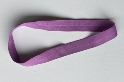 purple fabrics with quilt batting on white table