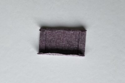 purple fabrics with quilt batting on white table