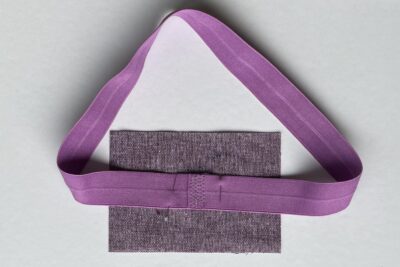 purple fabrics with quilt batting on white table