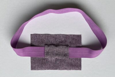 purple fabrics with quilt batting on white table