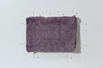 purple fabrics with quilt batting on white table