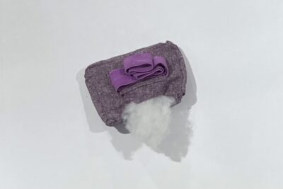 purple fabrics with quilt batting on white table