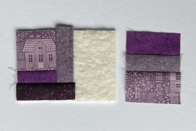 purple fabrics with quilt batting on white table