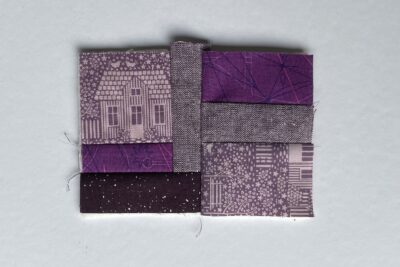 purple fabrics with quilt batting on white table