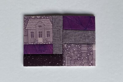 purple fabrics with quilt batting on white table