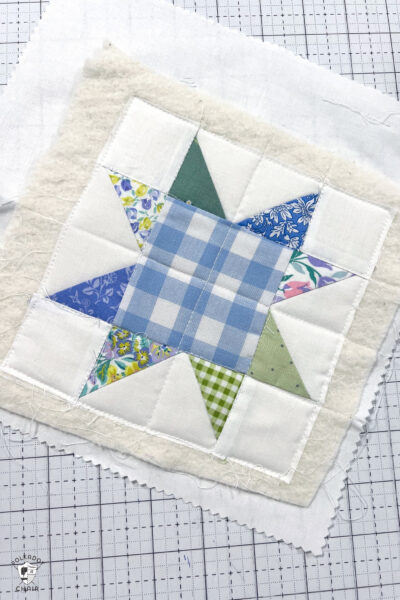 finished quilted piece blue and green fabrics with white background