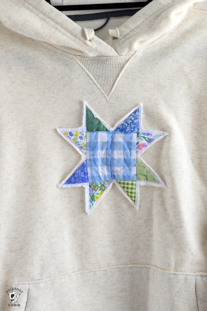 blue and green star quilt block sewn to sweatshirt