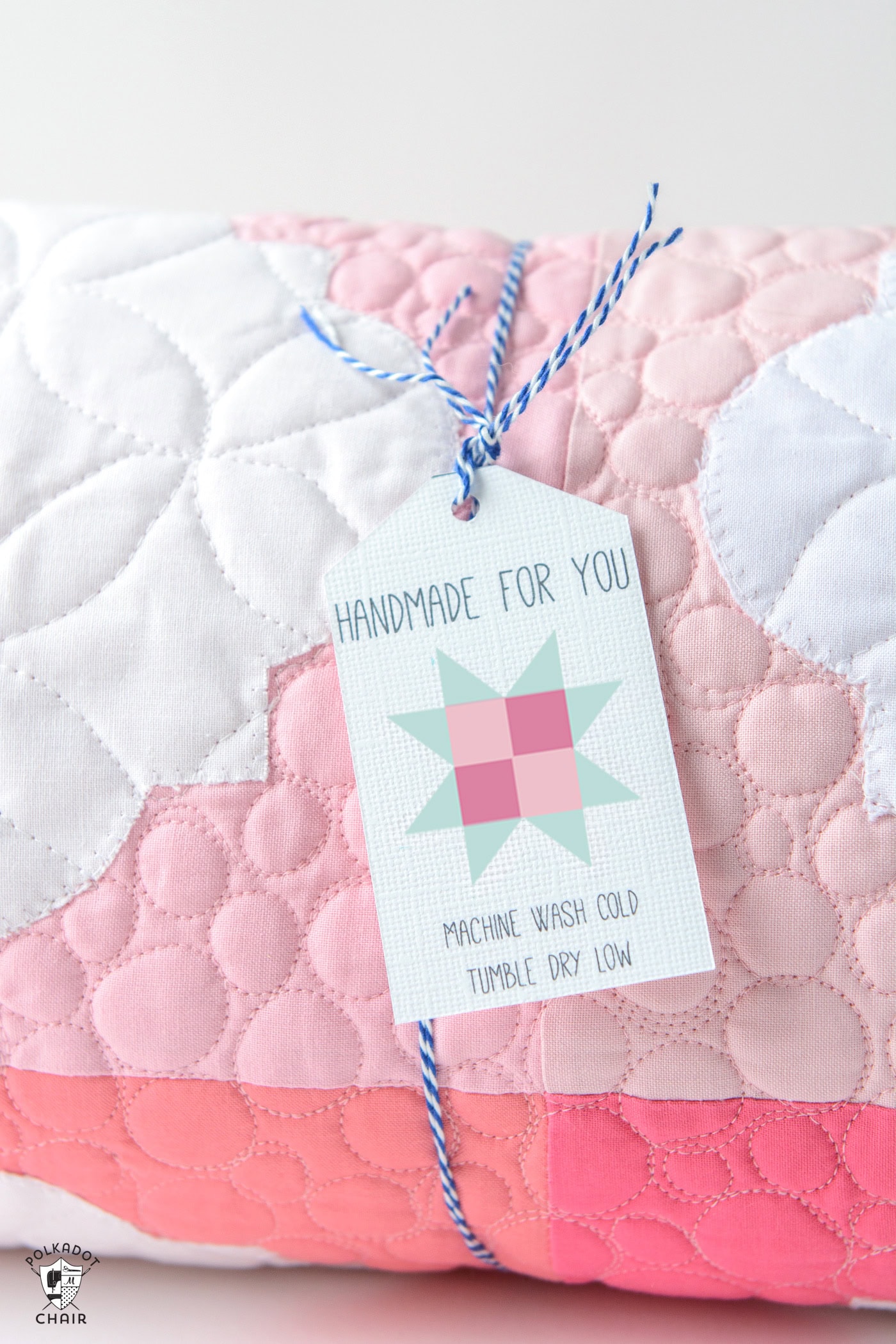 quilt care gift tag on pink quilt