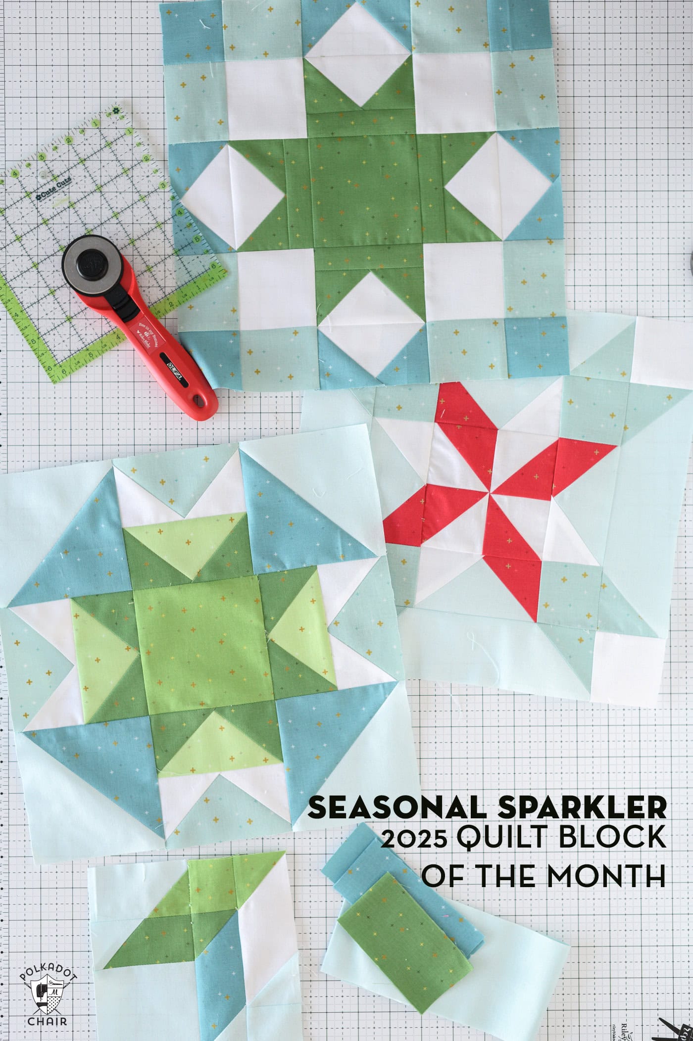 Blue and green quilt blocks on white cutting mat with quilt ruler and rotary cutter