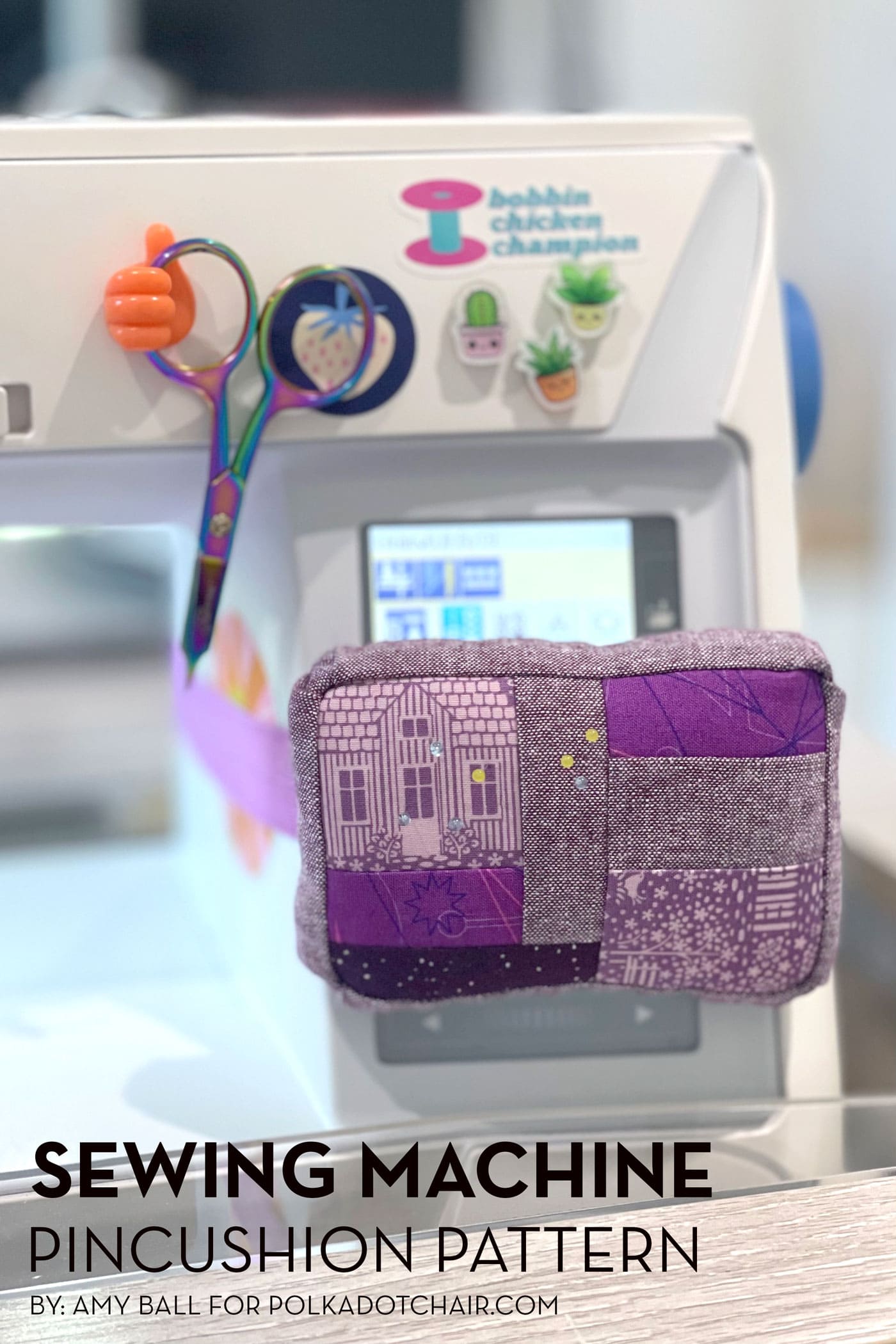 purple pincushion attached to white sewing machine with sewing notions