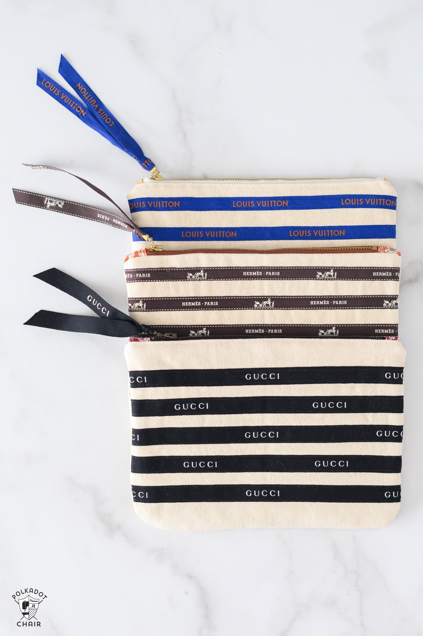 three zip pouches on marble table