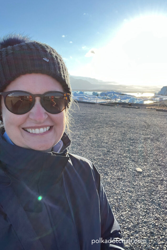 woman on glacier beach with hat and sunglasses