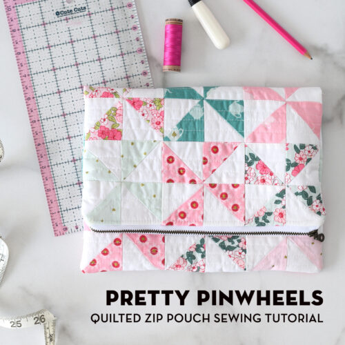 quilted pinwheel fold over zip pouch on white table with sewing notions