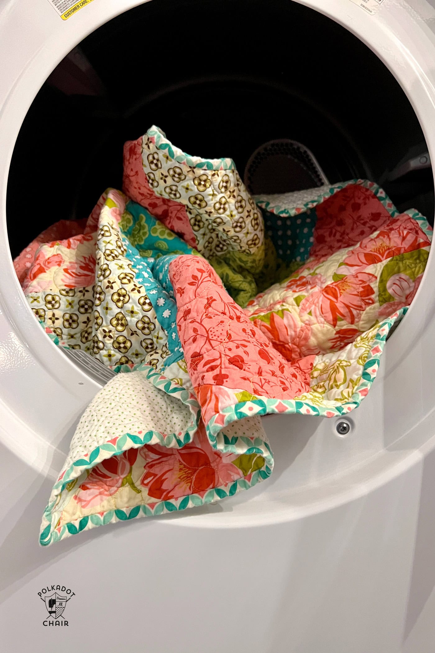 quilt hanging out of dryer