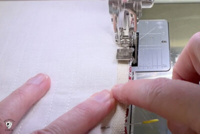 canvas fabric under presser foot of sewing machine