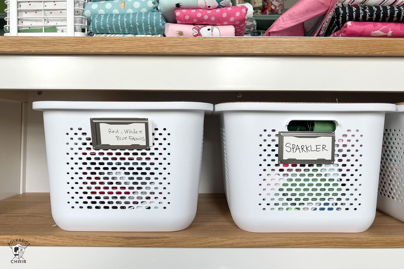 two plastic bins on shelf in sewing room with labels