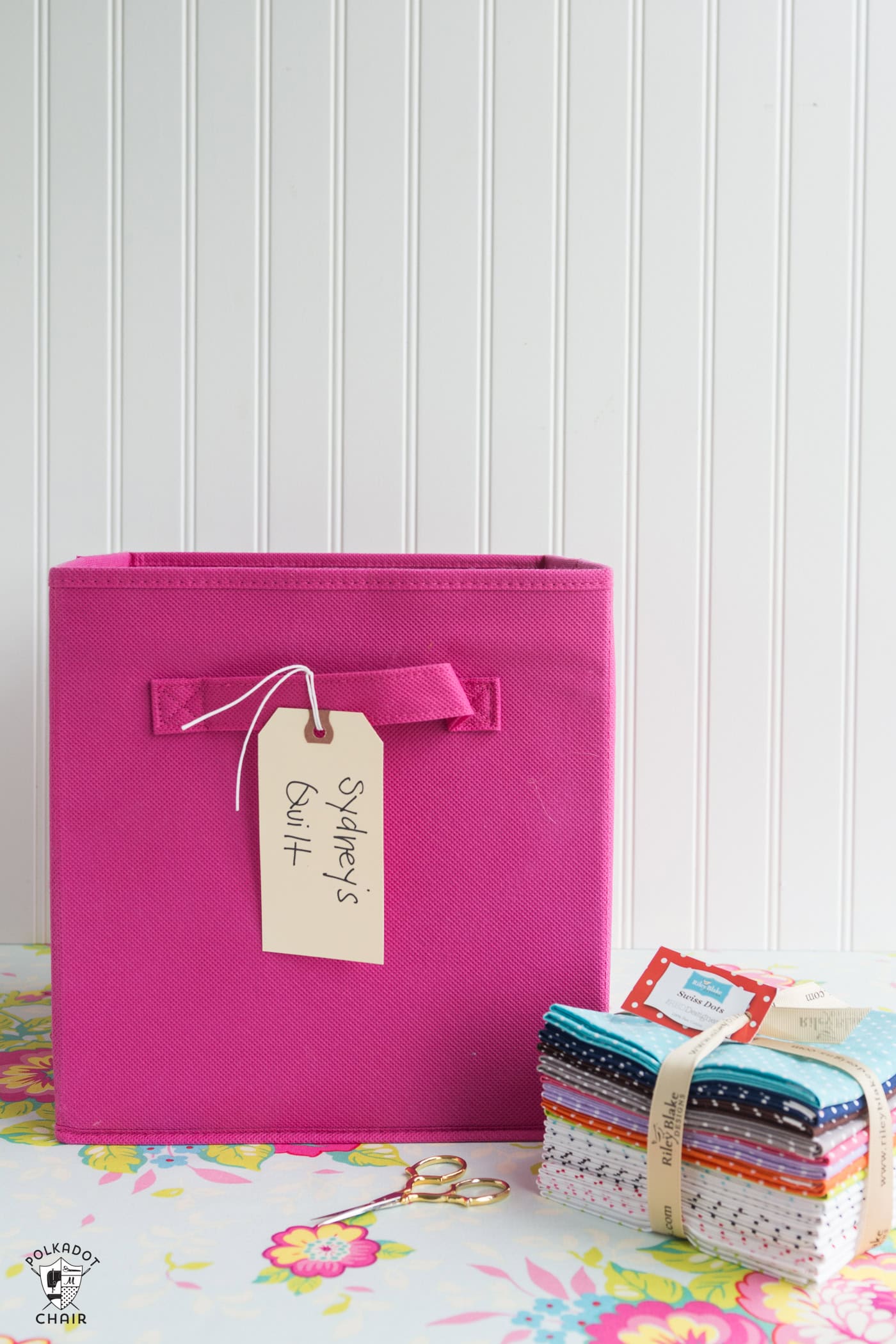 Canvas bin on white table with fabric