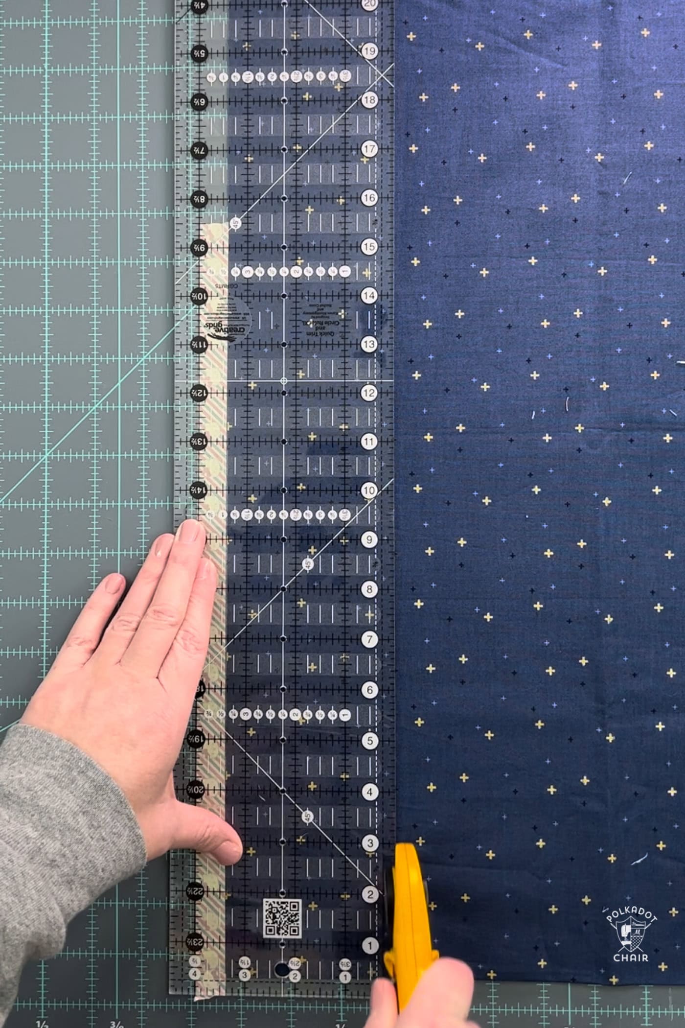 quilt ruler and blue fabric on cutting mat