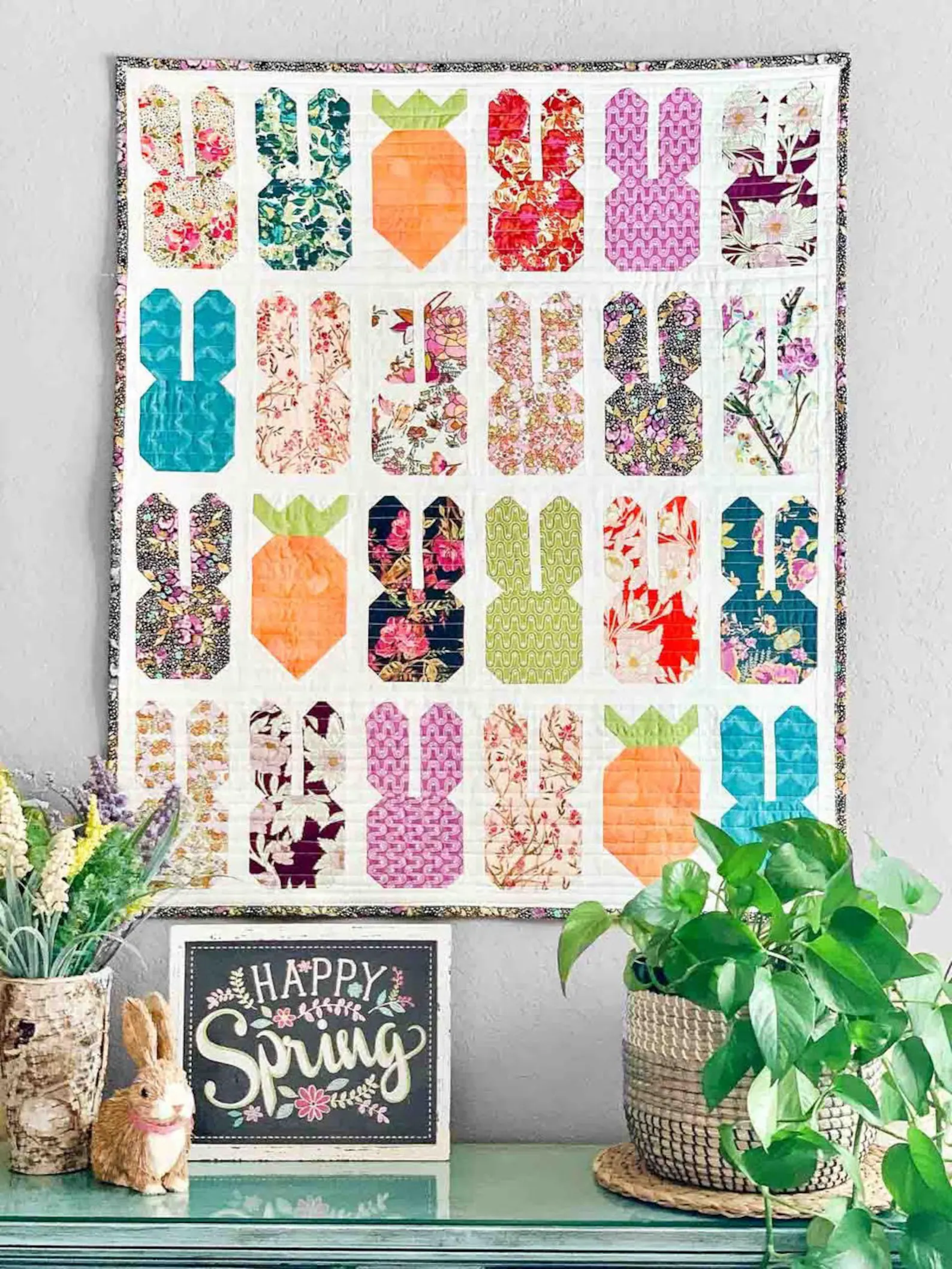 easter quilt on wall with flowers in foreground