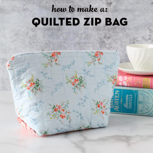 blue zippered pouch on table with books in the background