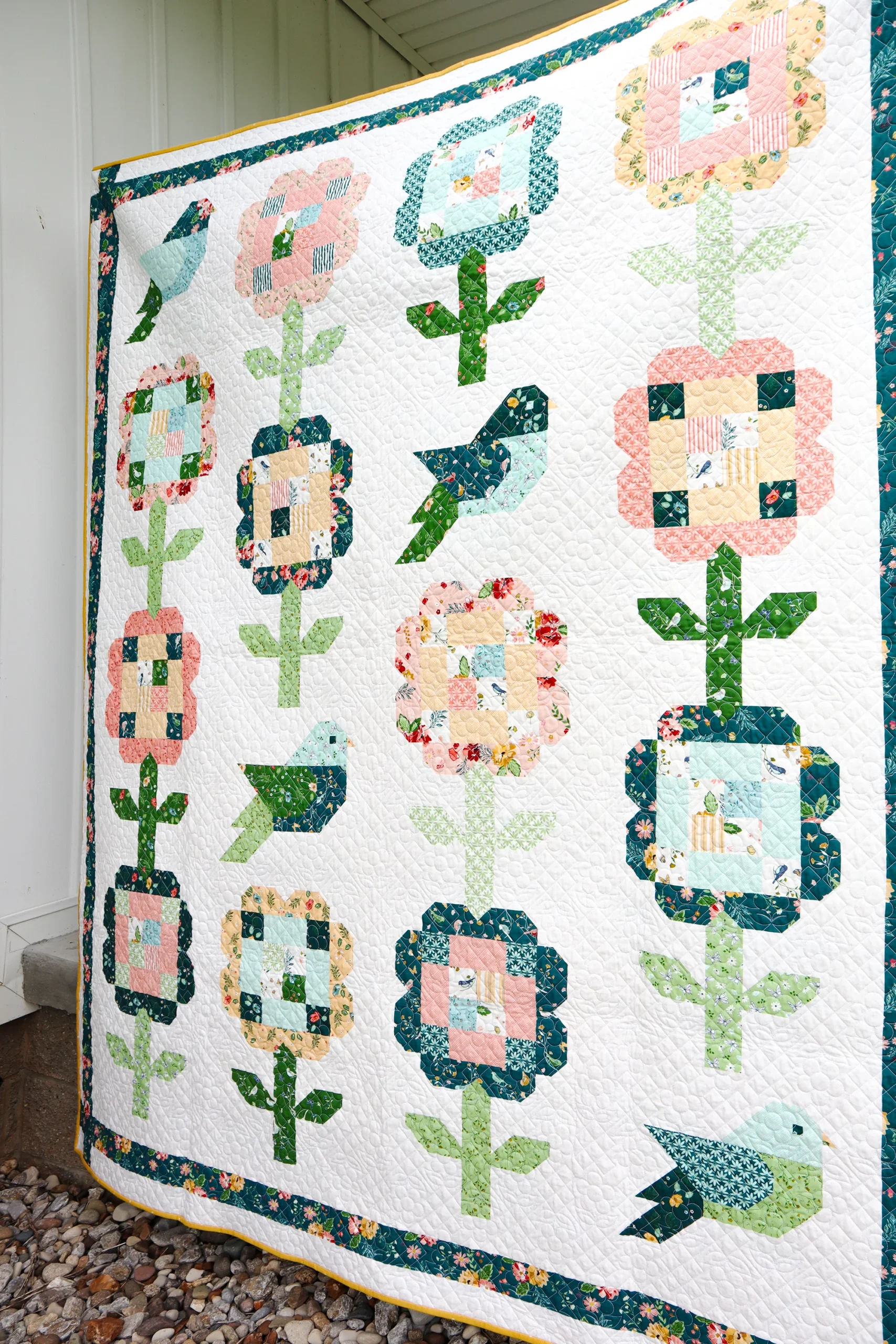 quilt featuring flower and bird quilt blocks