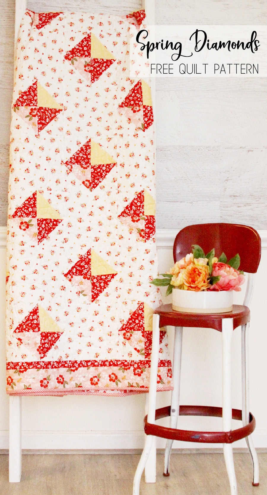 red and yellow vintage quilt on wall with red chair