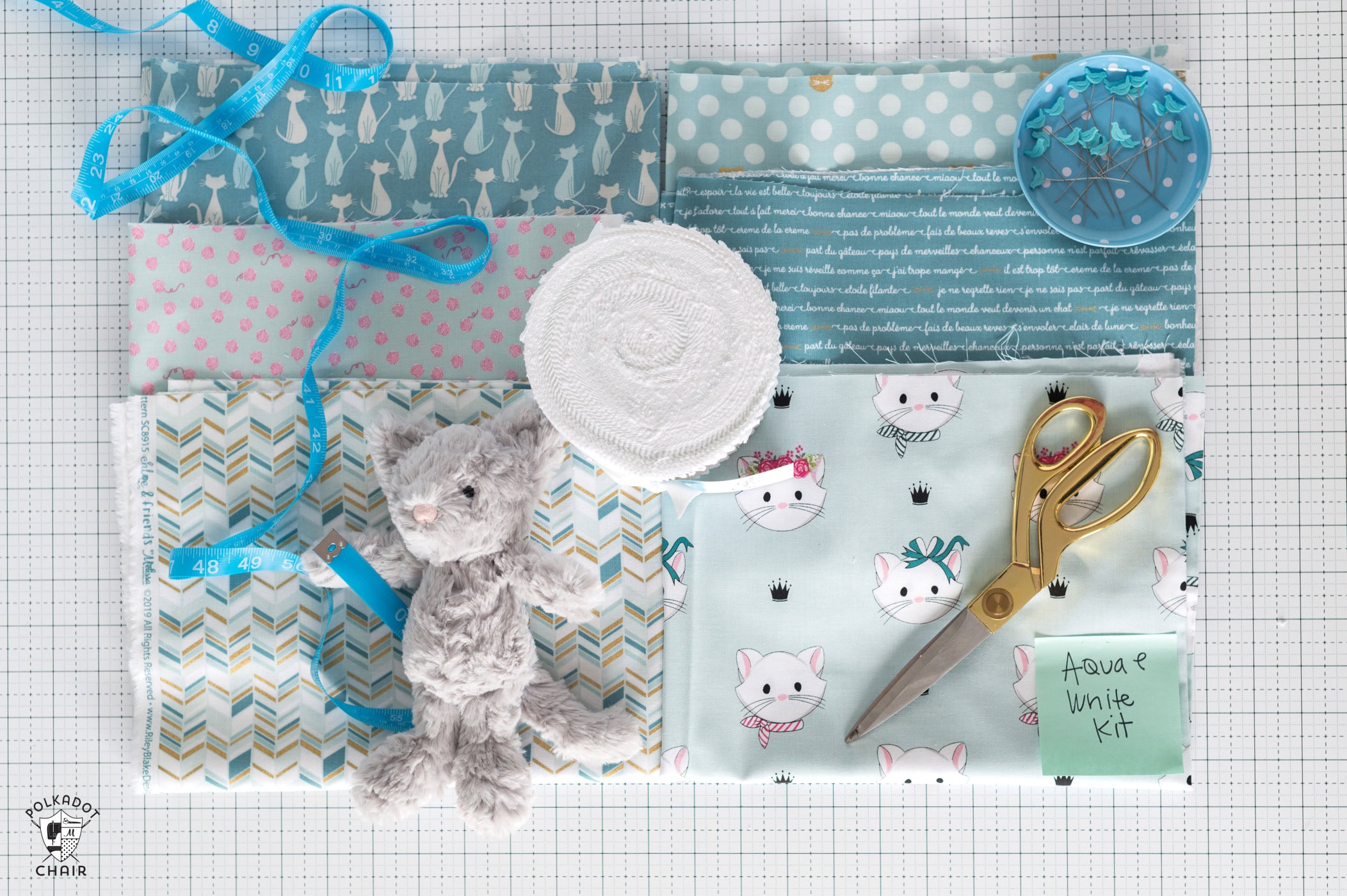 blue fabrics on cutting mat with sewing notions