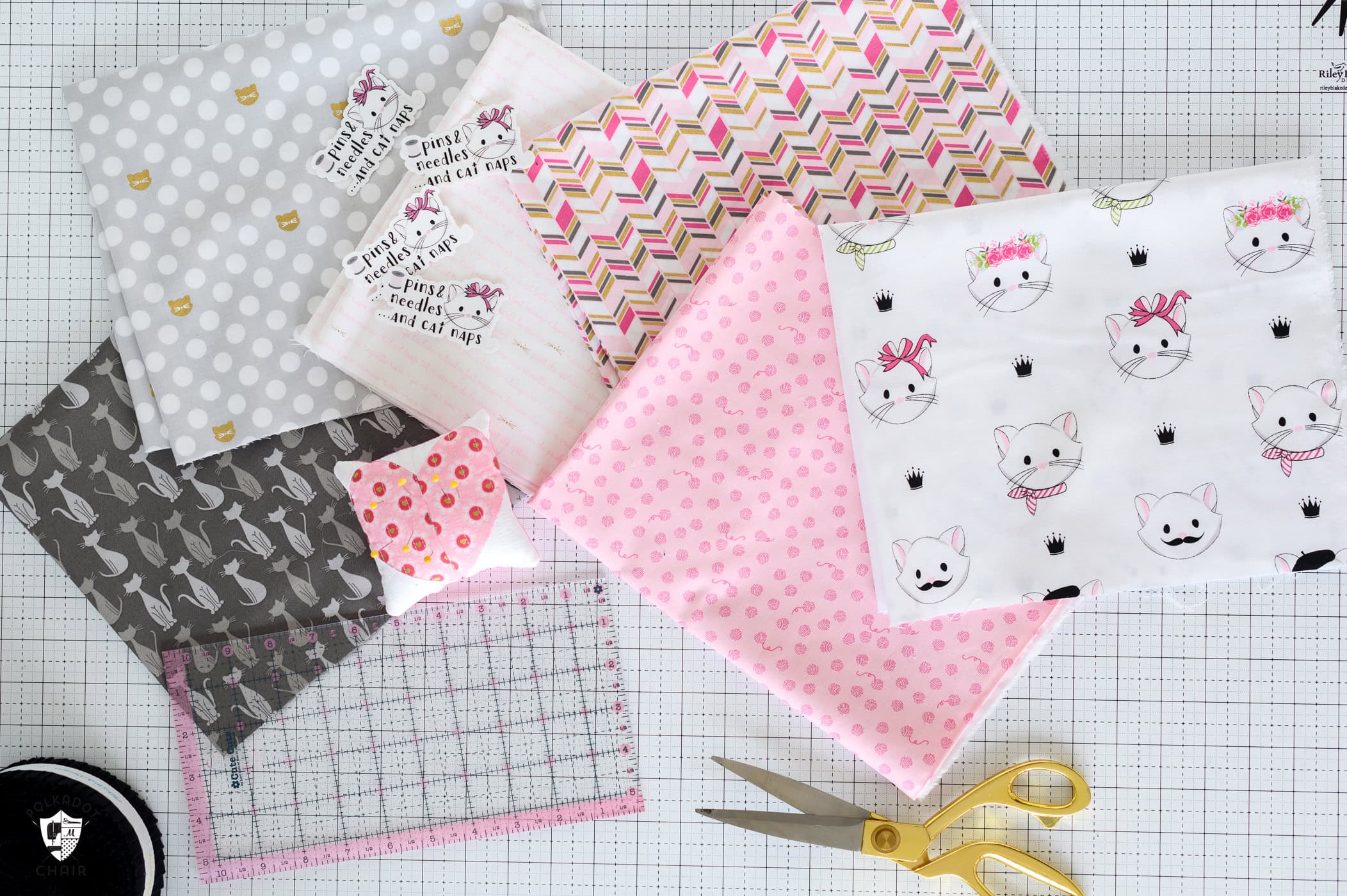 pink and gray fabric on white cutting mat