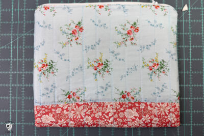 construction process of zip bag featuring blue floral fabric and coral floral fabric