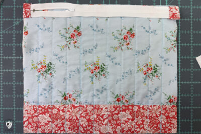 construction process of zip bag featuring blue floral fabric and coral floral fabric