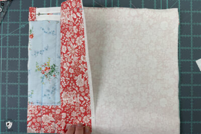 construction process of zip bag featuring blue floral fabric and coral floral fabric