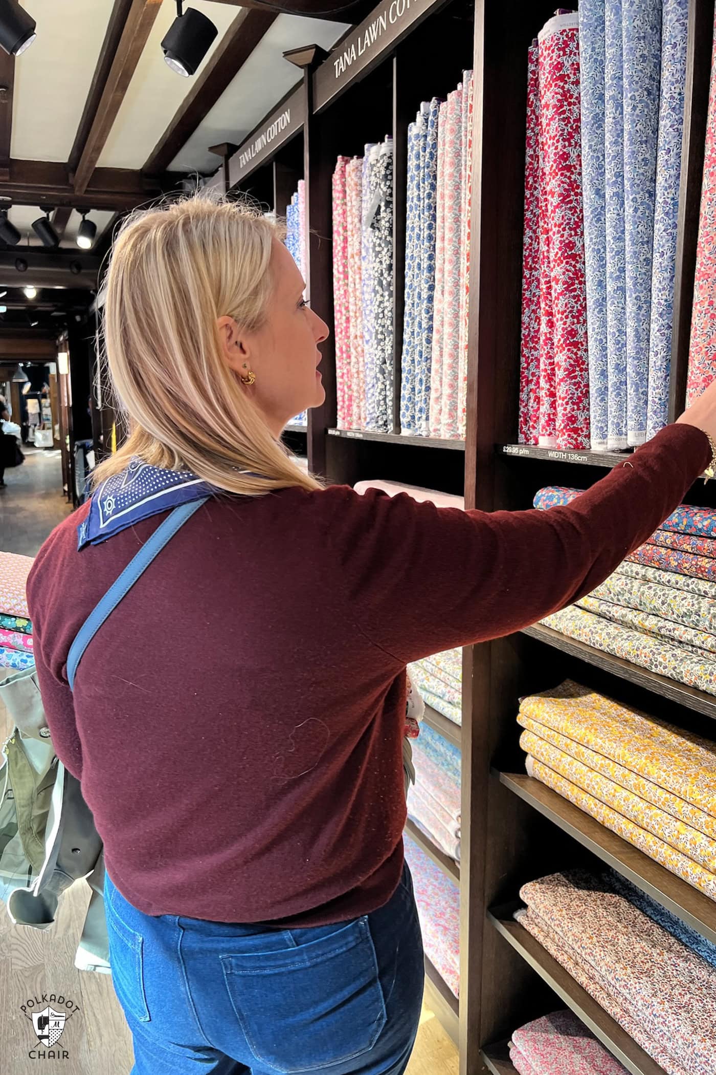 woman looking at fabric ins tore