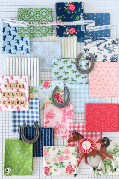selection of fabric swatches on white table with various props