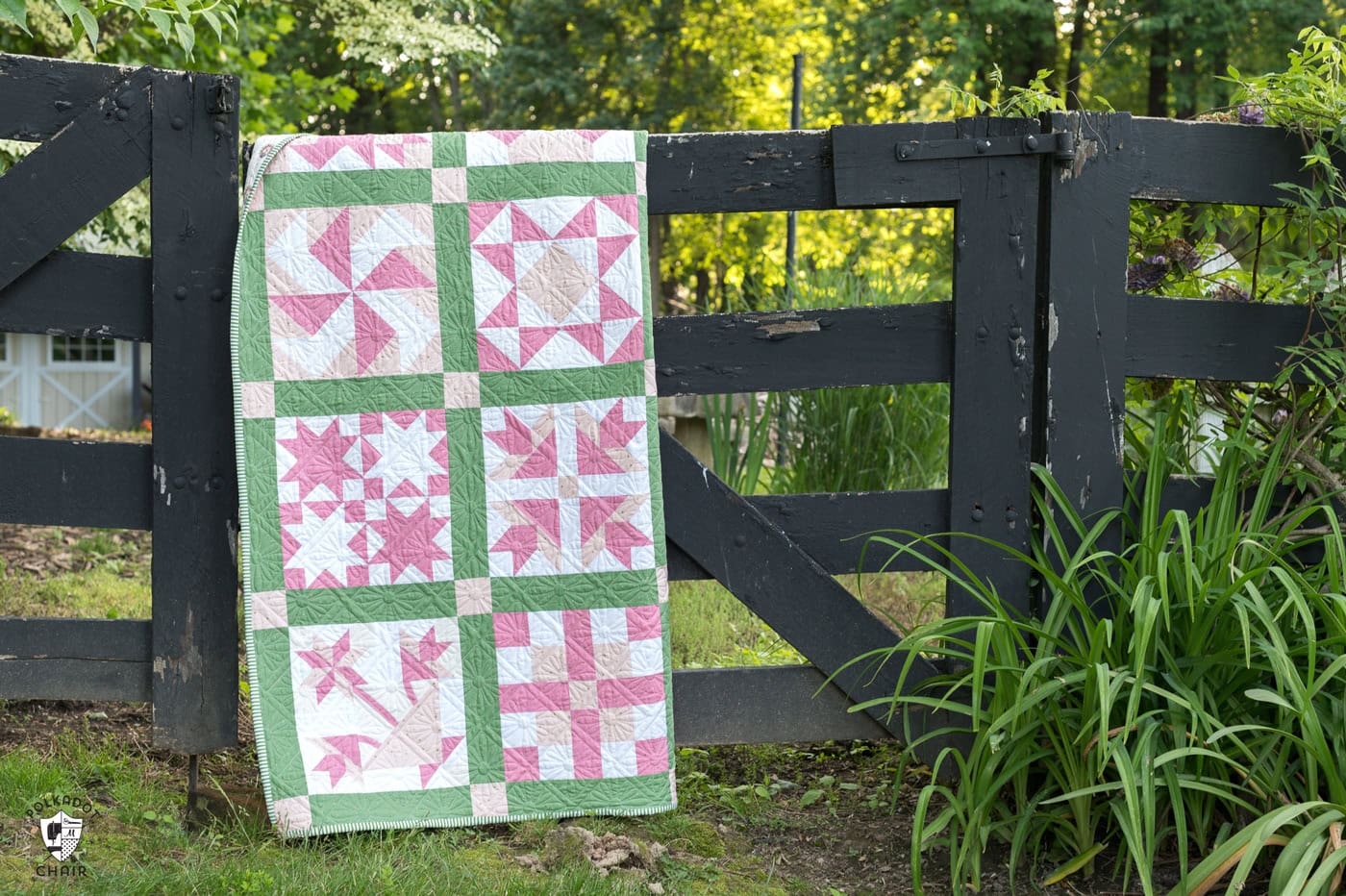 pink and green sampler quilt outdoors