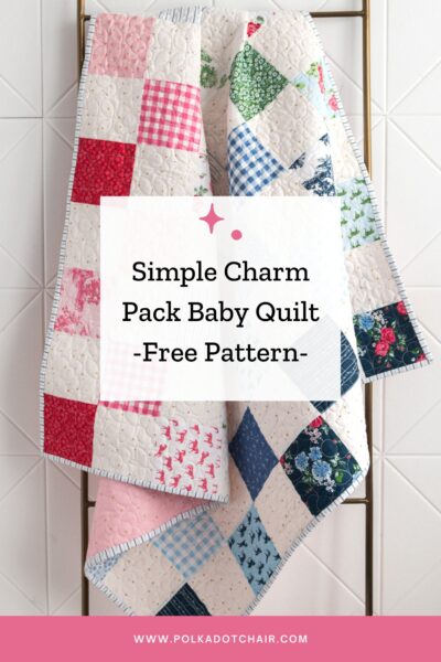 patchwork quilt in white and blues, greens and pinks hanging on quilt ladder