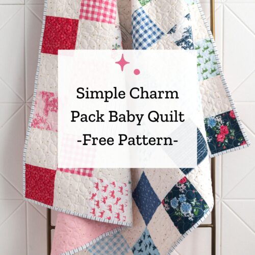 patchwork quilt in white and blues, greens and pinks hanging on quilt ladder