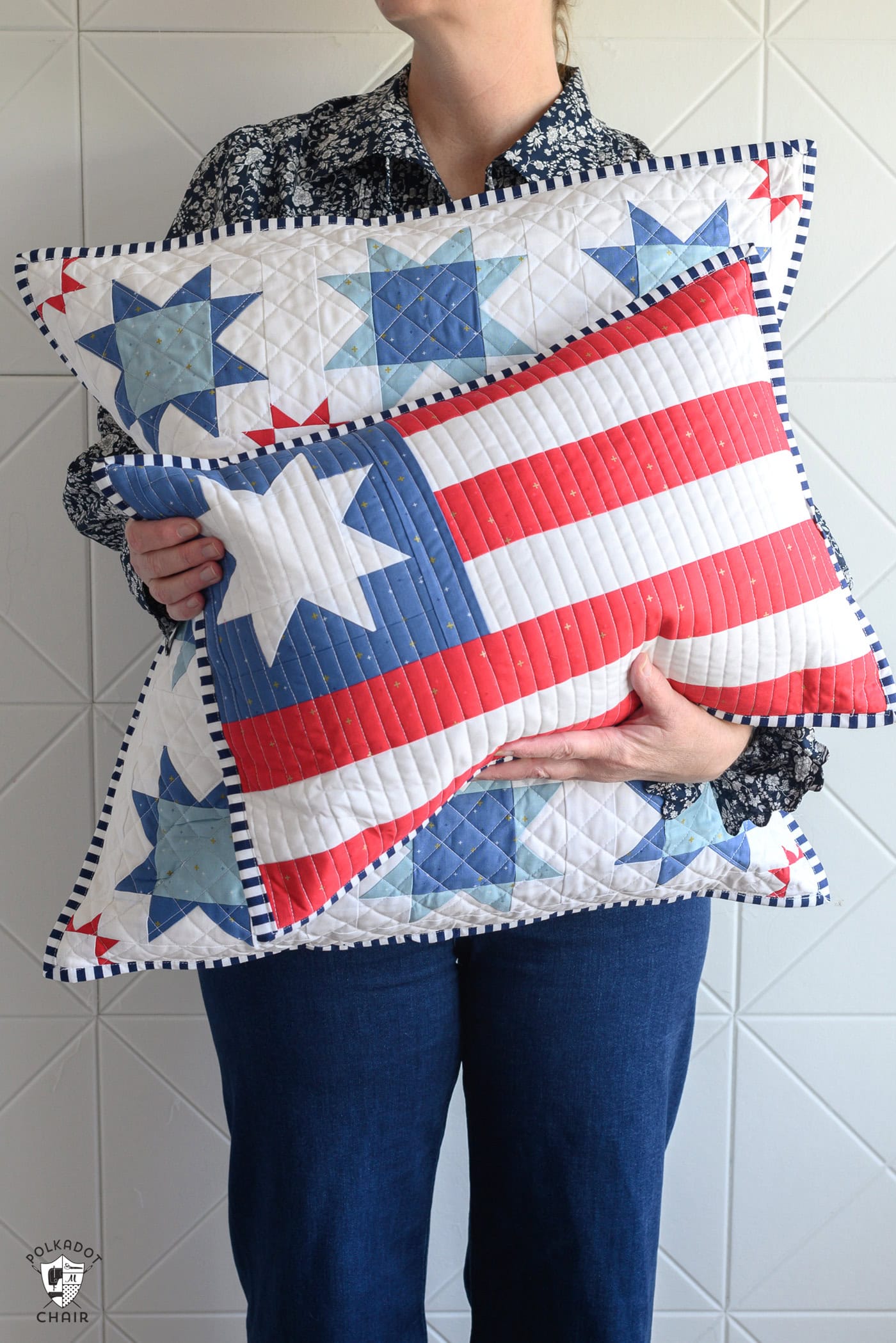 woman holding two red white and blue flag pillows