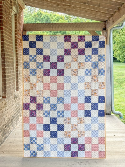 colorful patchwork quilt on porch of old building