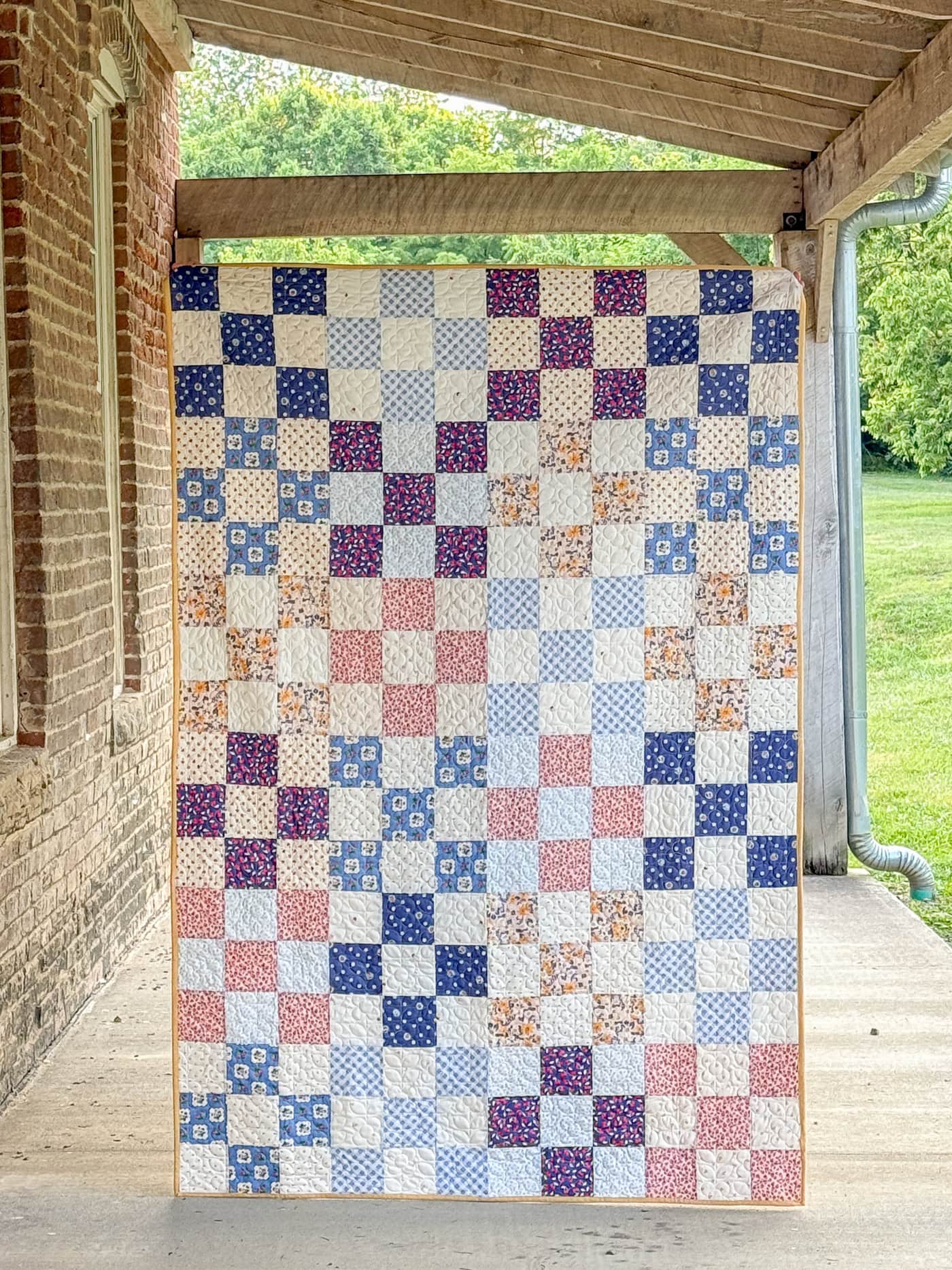 colorful patchwork quilt on porch of old building