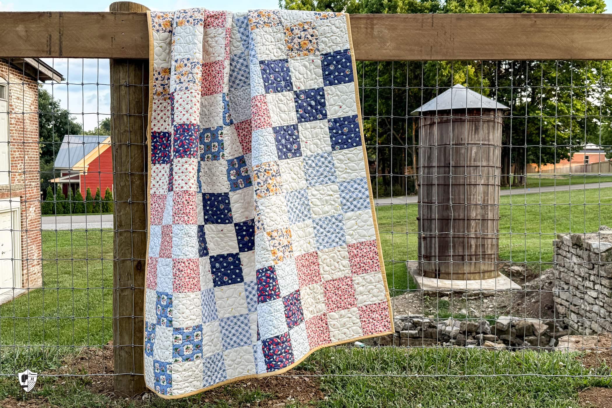 quilt hanging on old fence
