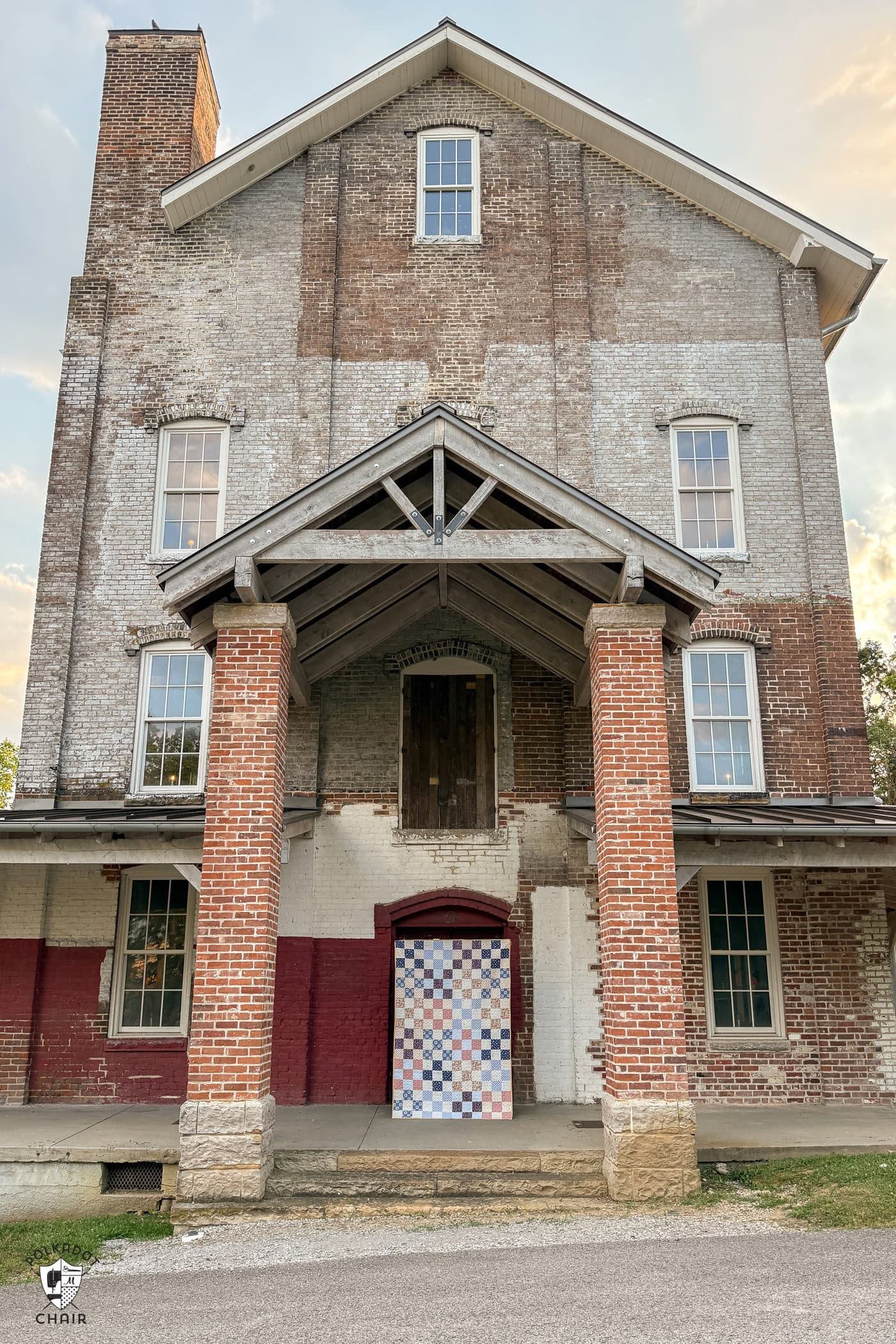 patchwork quilt in front of old building
