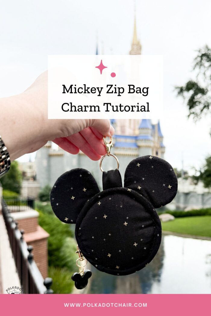 hand holding mickey head shaped bag charm outdoors