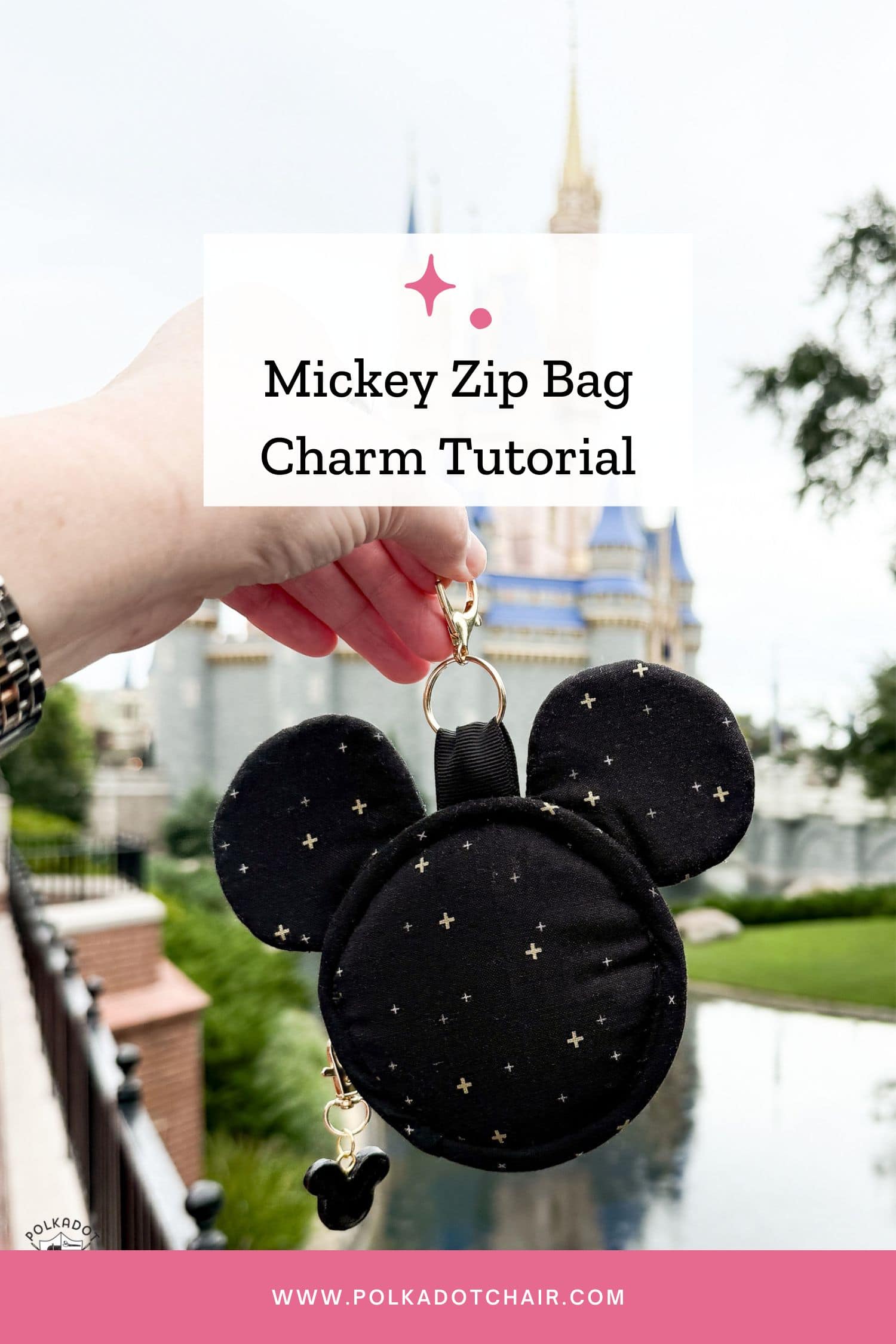 hand holding mickey head shaped bag charm outdoors