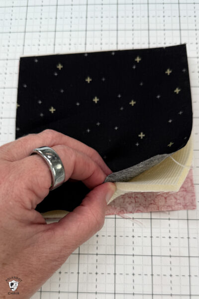black fabric on cutting mat showing construction steps of zip pouch