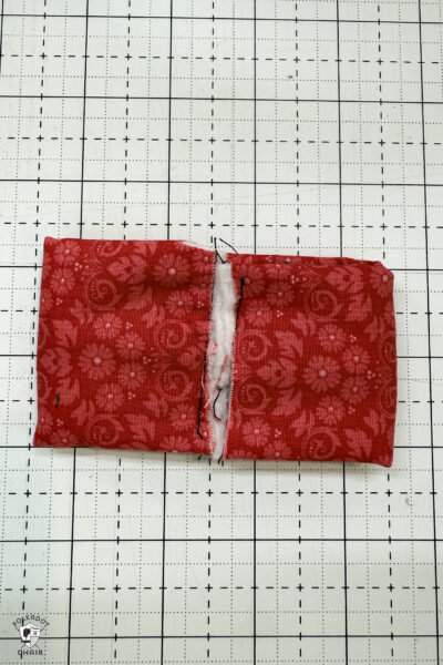 red fabric on cutting mat with showing construction steps of zip pouch