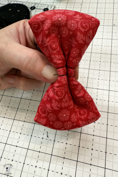 red fabric on cutting mat with showing construction steps of zip pouch