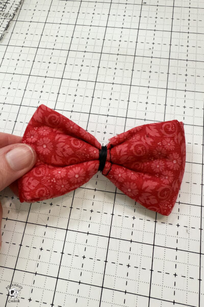 red fabric on cutting mat with showing construction steps of zip pouch